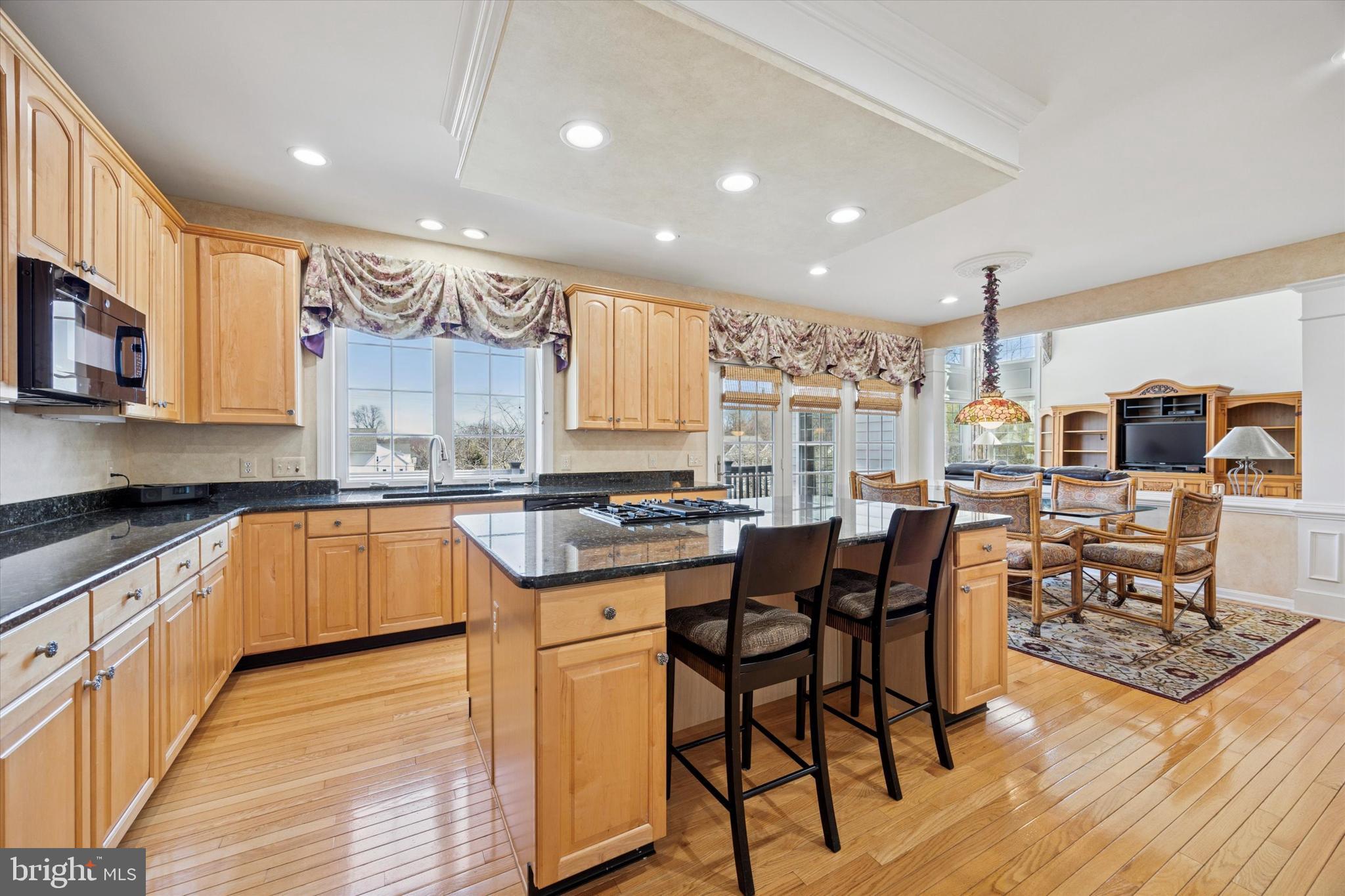 128 Applegate Drive West Chester, PA 19382 - Photo 18 of 36 a kitchen with stainless steel appliances granite countertop wooden floor sink stove dining table and chairs
