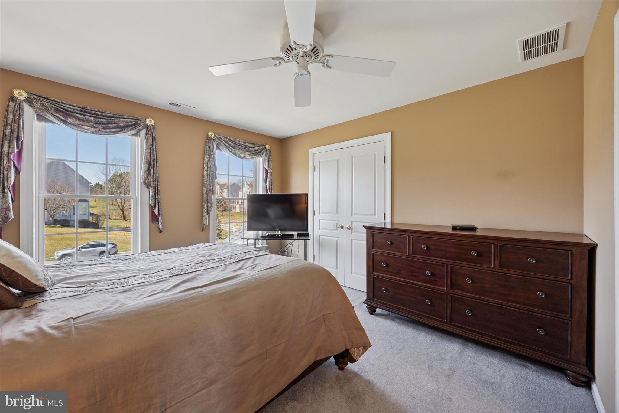 128 Applegate Drive West Chester, PA 19382 - Photo 25 of 36 a bedroom with a bed and a dresser with mirror