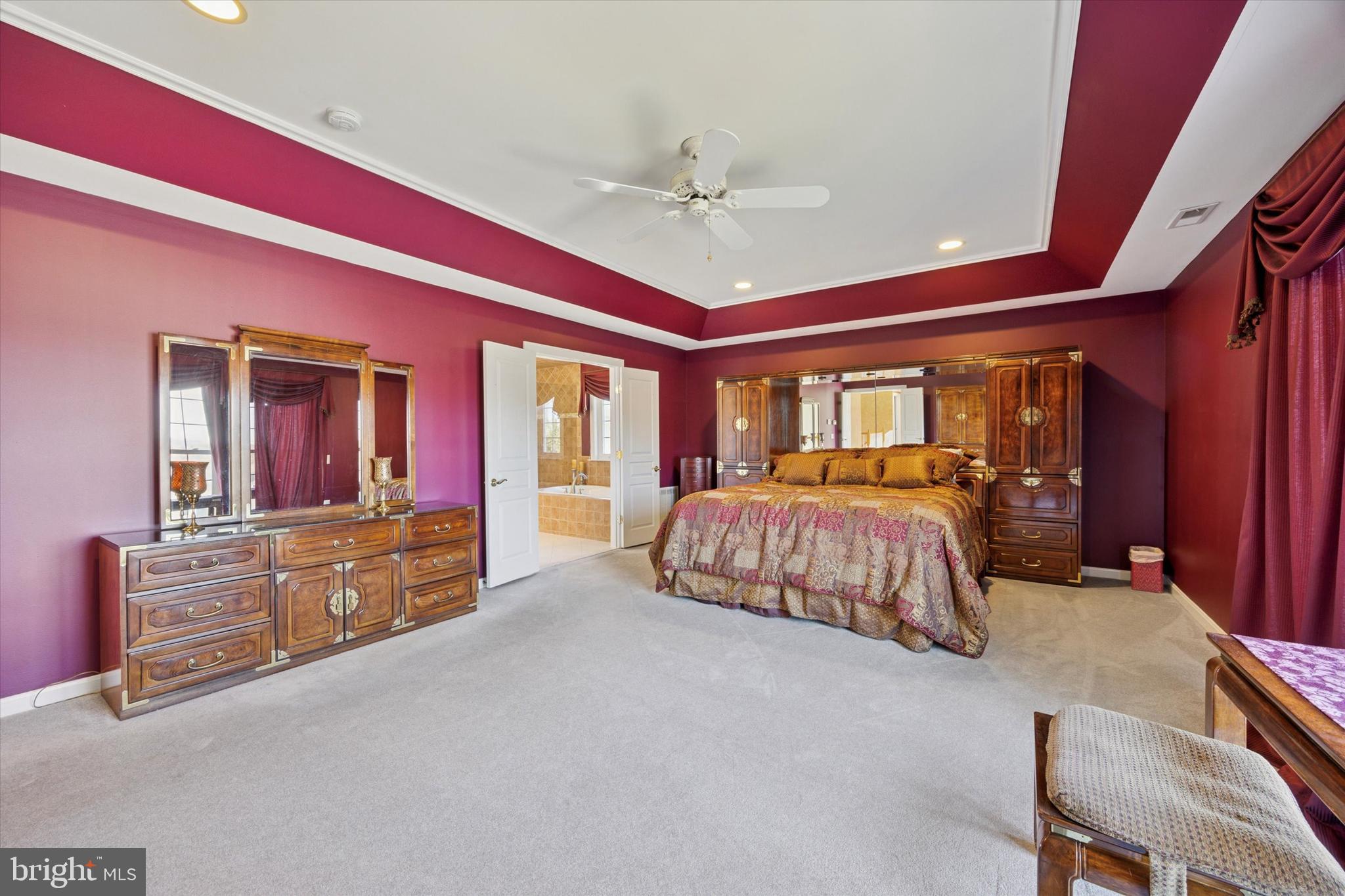 128 Applegate Drive West Chester, PA 19382 - Photo 28 of 36 a bedroom with a large bed and a chandelier