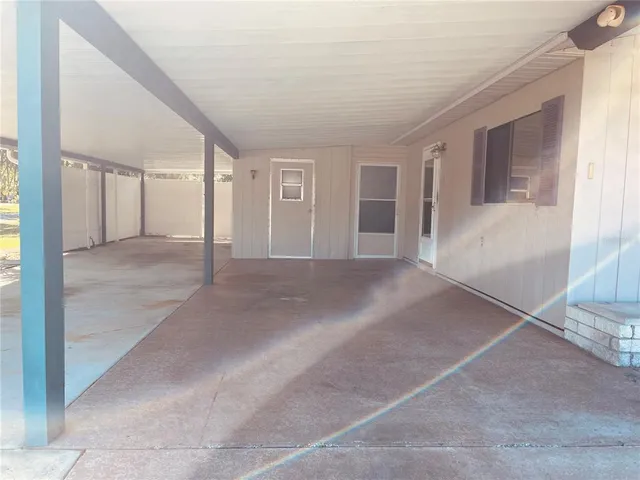 a view of a big room with windows and chandelier