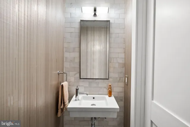 a bathroom with a sink a mirror and shower