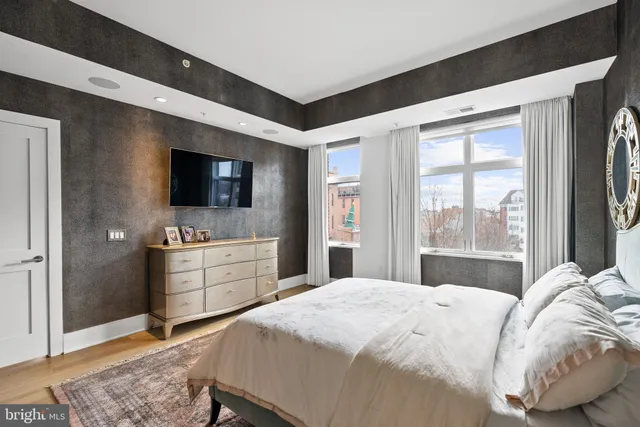 a bedroom with a large bed and a flat screen tv