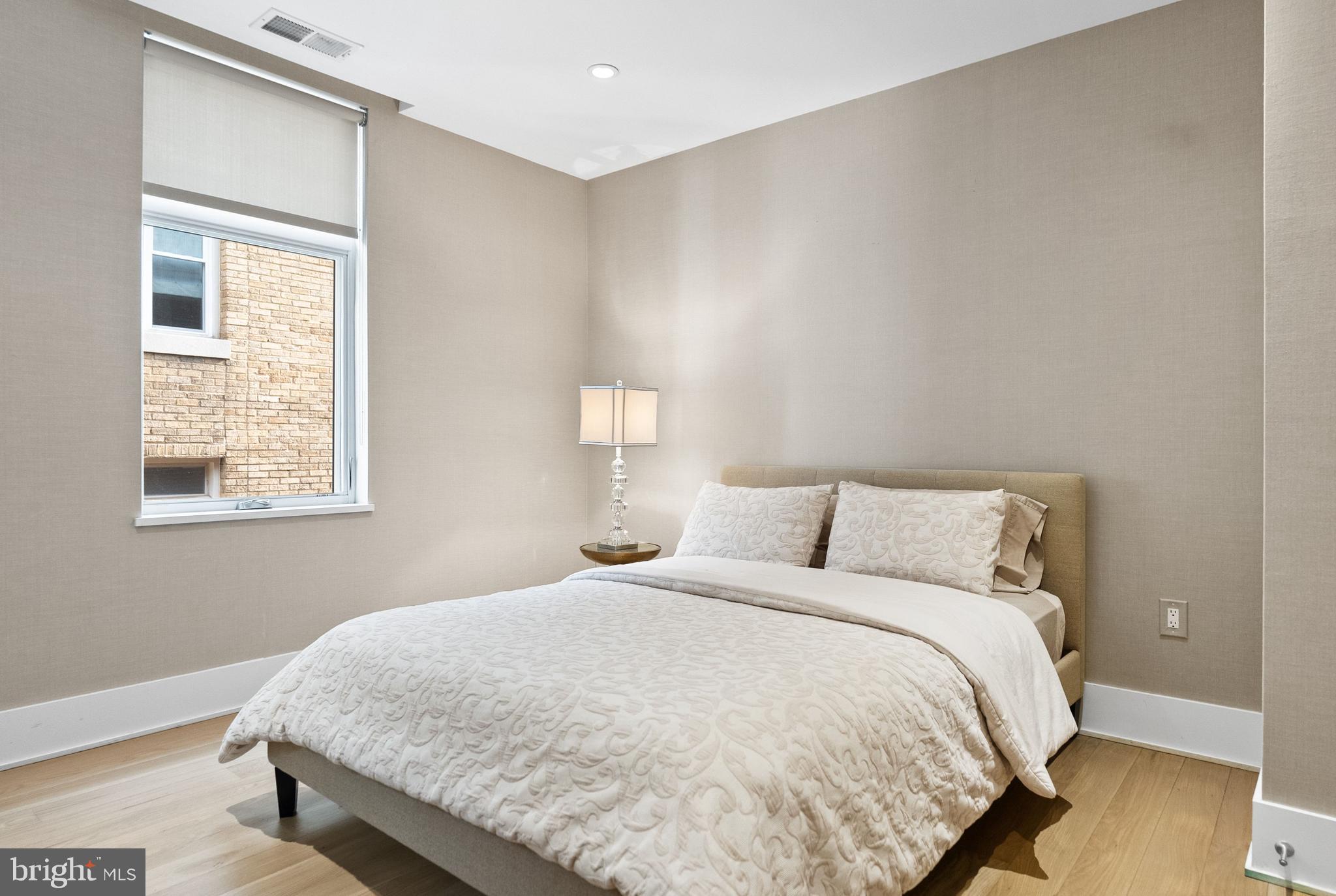 2225 California Street Northwest, Unit PH1 Washington, DC 20008 - Photo 15 of 31 a large bed sitting in a bedroom next to a window