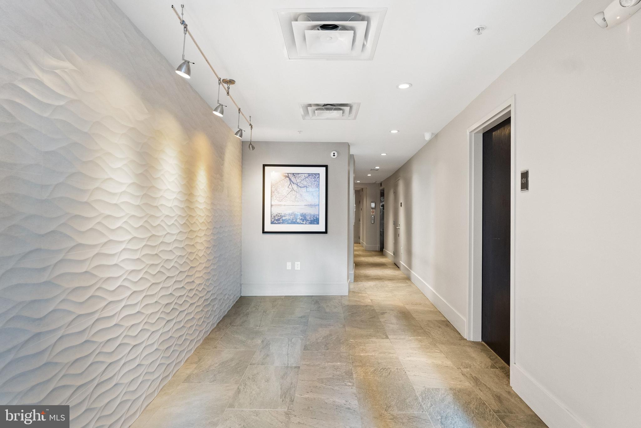2225 California Street Northwest, Unit PH1 Washington, DC 20008 - Photo 25 of 31 a view of a hallway with wooden floor and a bathroom