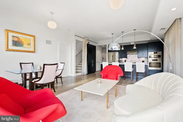 a living room with furniture and kitchen view