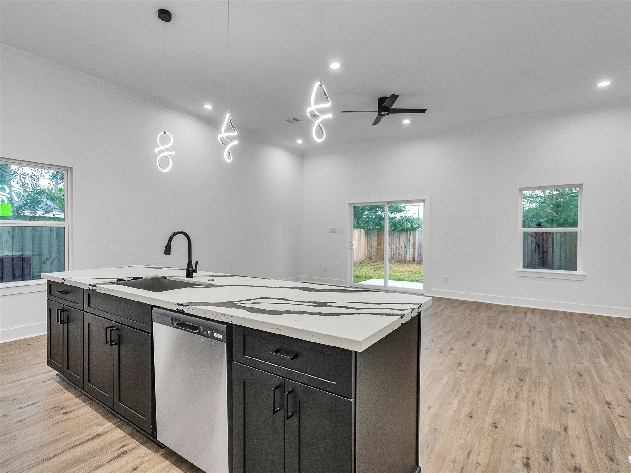 7358 Guadalcanal Road, Unit B Houston, TX 77033 - Photo 12 of 35 a kitchen with a sink cabinets and wooden floor
