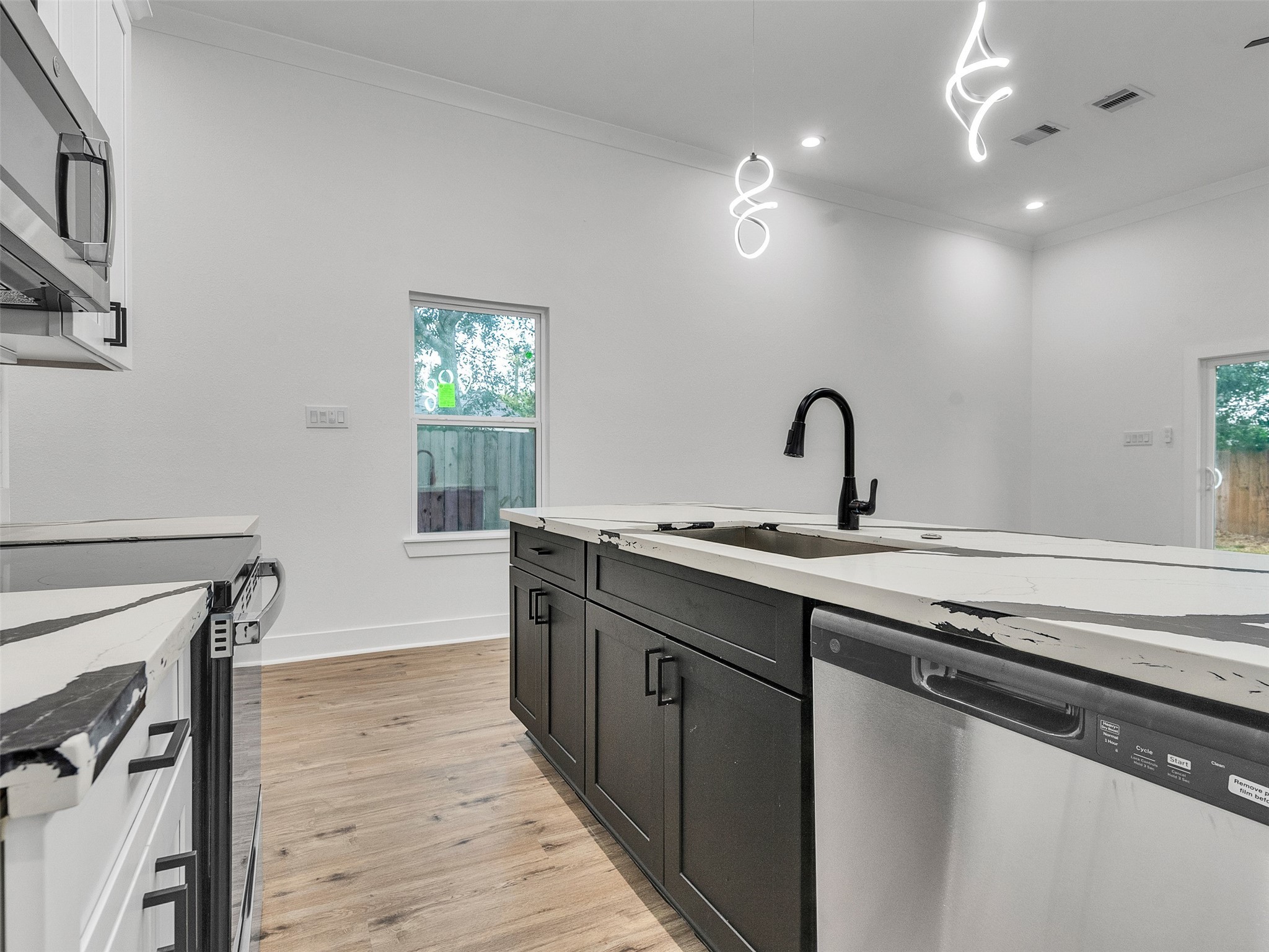7358 Guadalcanal Road, Unit B Houston, TX 77033 - Photo 13 of 35 a kitchen with granite countertop a sink cabinets and wooden floor