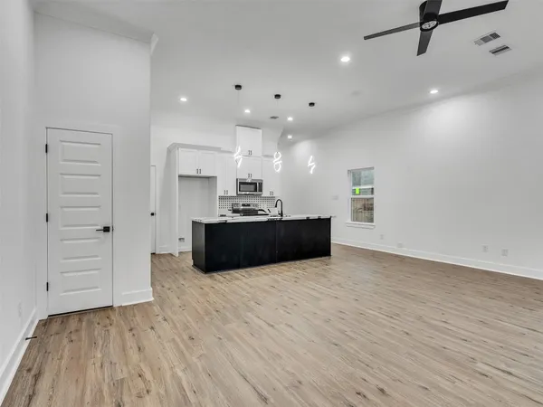 a view of kitchen with cabinets and wooden floor