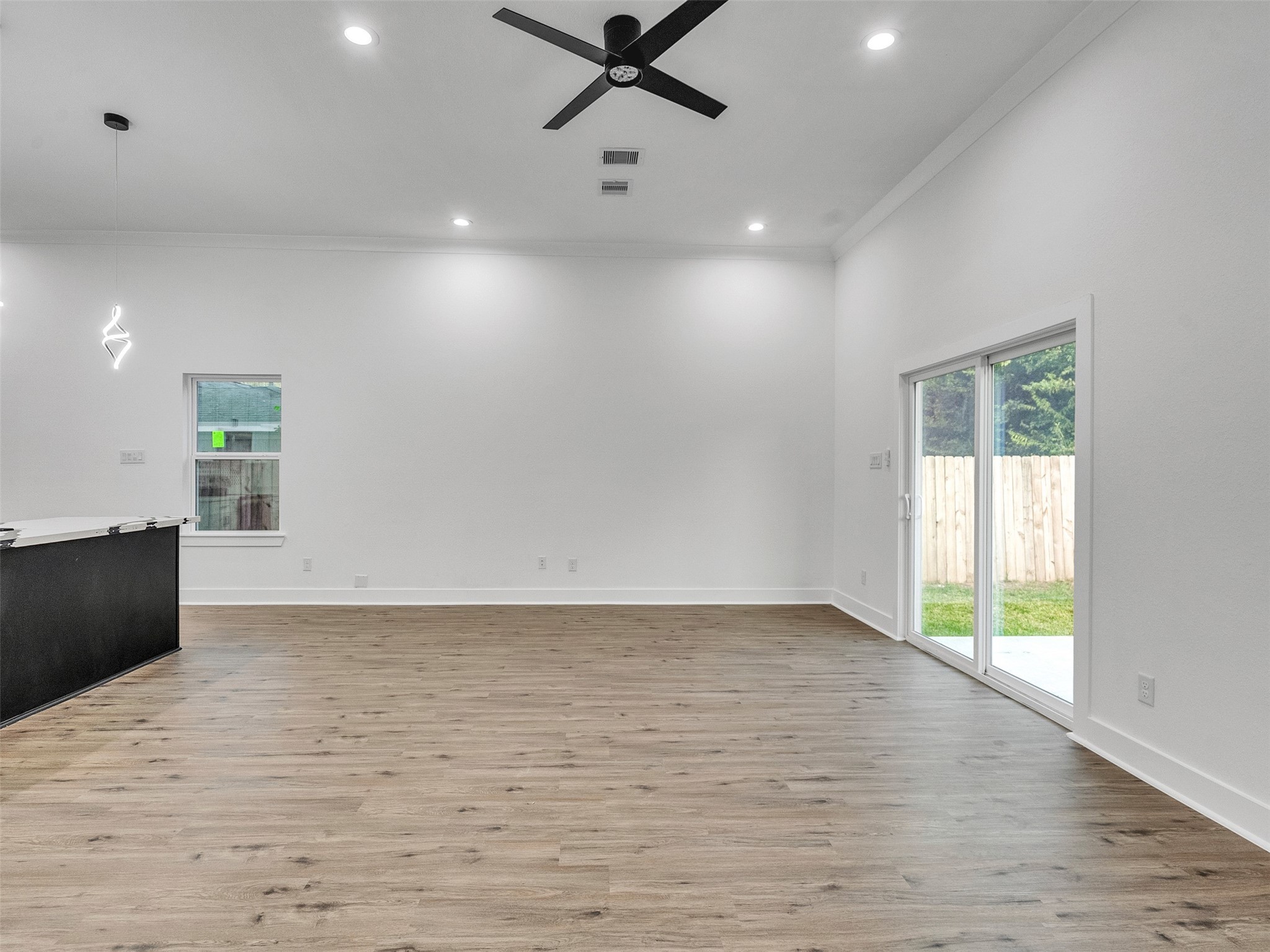 7358 Guadalcanal Road, Unit B Houston, TX 77033 - Photo 17 of 35 an empty room with wooden floor and windows