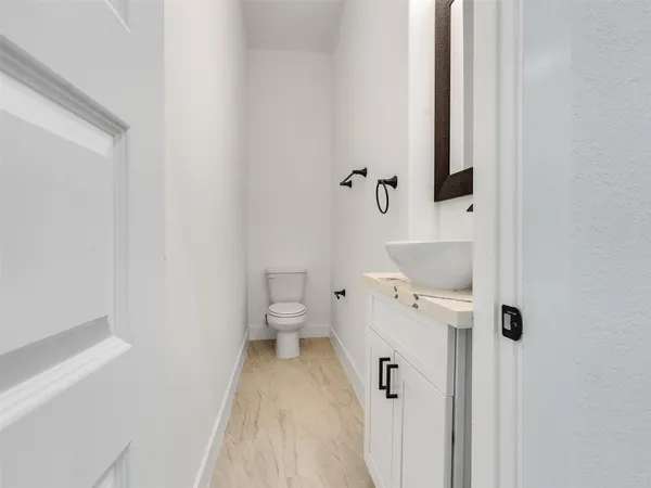 a bathroom with a toilet sink and shower