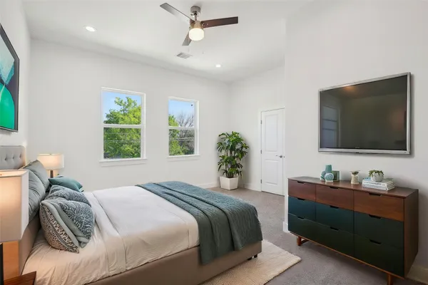 a bedroom with a bed and a flat screen tv