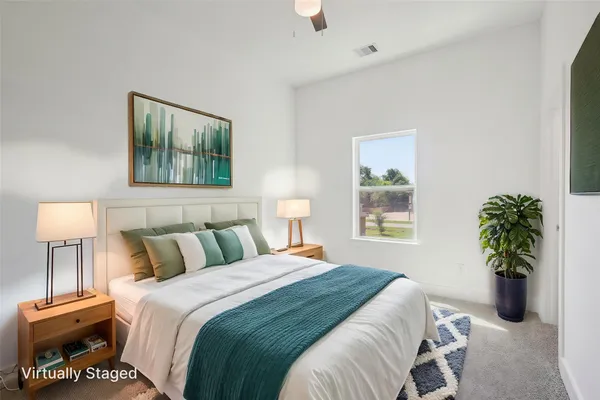 a bedroom with a bed and a potted plant