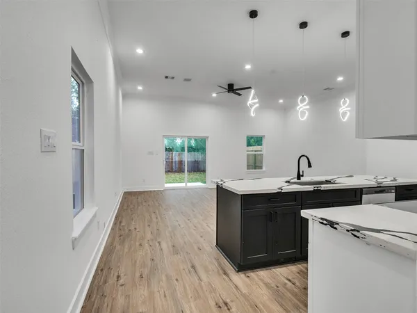 a view of a kitchen counter space and wooden floor