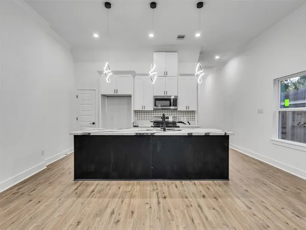 a view of kitchen with granite countertop window