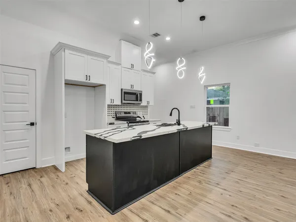 a view of kitchen with sink and wooden floor