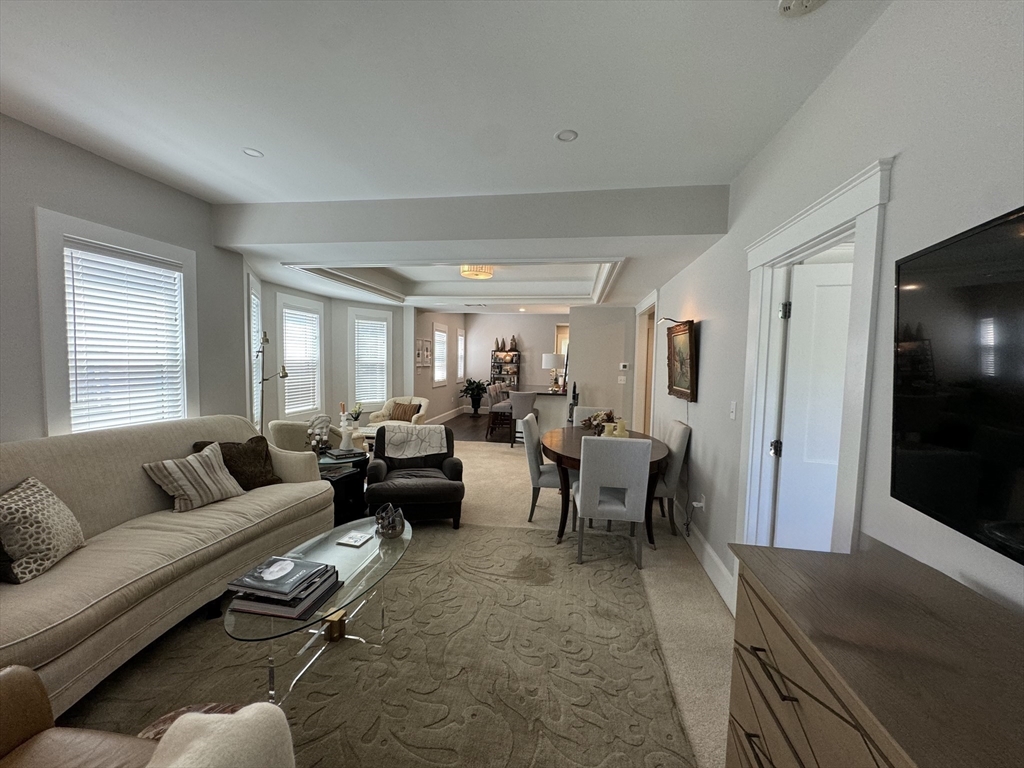 32 Atherton Road, Unit 2 Brookline, MA 02446 - Photo 11 of 42 a living room with furniture wooden floor and window