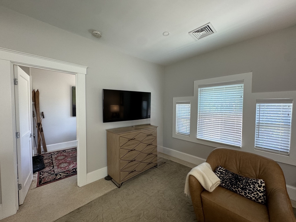 32 Atherton Road, Unit 2 Brookline, MA 02446 - Photo 14 of 42 a living room with furniture and a flat screen tv