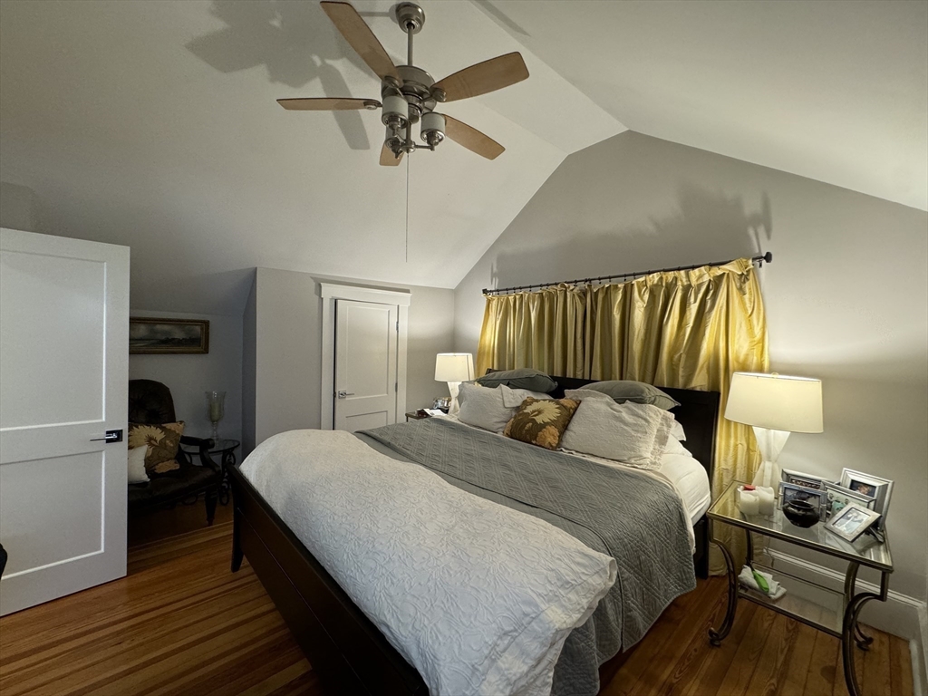 32 Atherton Road, Unit 2 Brookline, MA 02446 - Photo 24 of 42 a bedroom with a bed and a chandelier