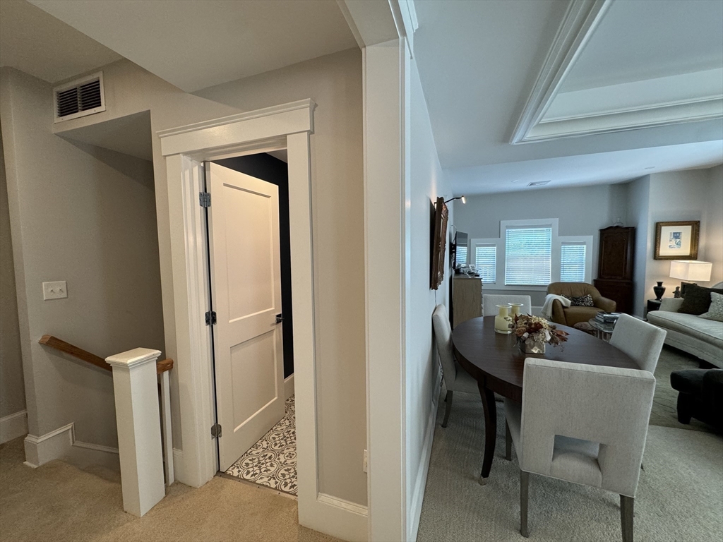 32 Atherton Road, Unit 2 Brookline, MA 02446 - Photo 31 of 42 a view of a hallway with workspace and a couch