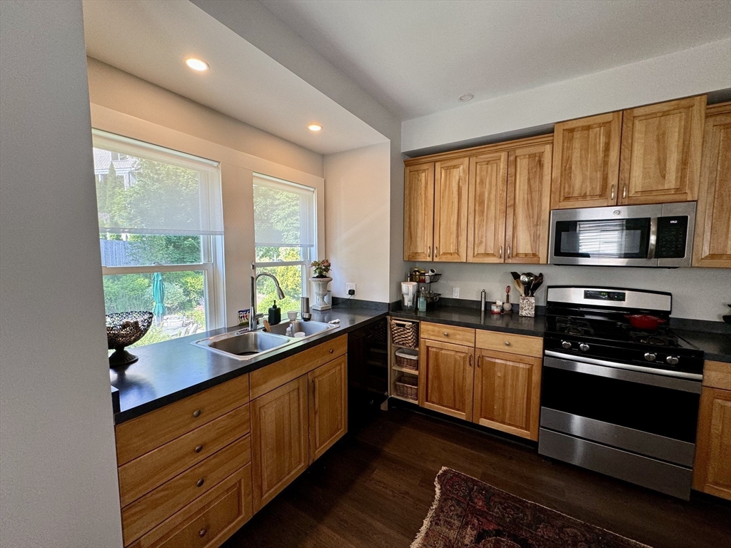 32 Atherton Road, Unit 2 Brookline, MA 02446 - Photo 34 of 42 a kitchen with stainless steel appliances kitchen island granite countertop a sink stove and cabinets