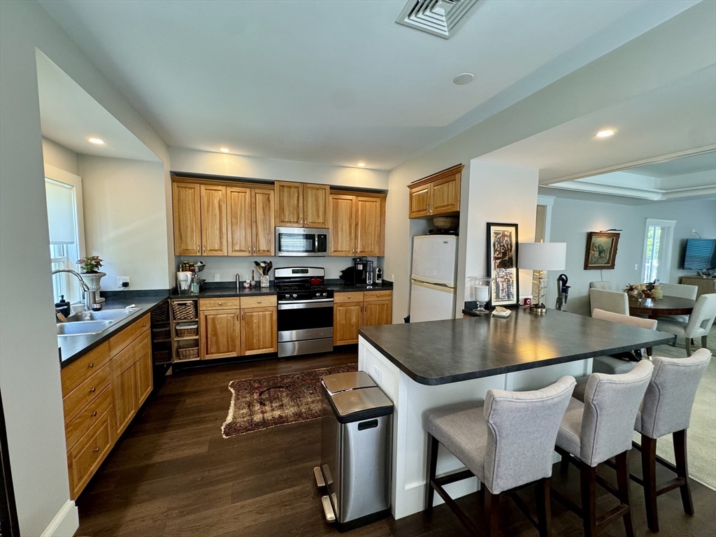 32 Atherton Road, Unit 2 Brookline, MA 02446 - Photo 36 of 42 a large kitchen with lots of counter space a sink and stainless steel appliances