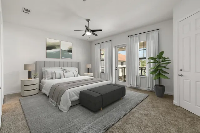 a spacious bedroom with a large bed and a chandelier