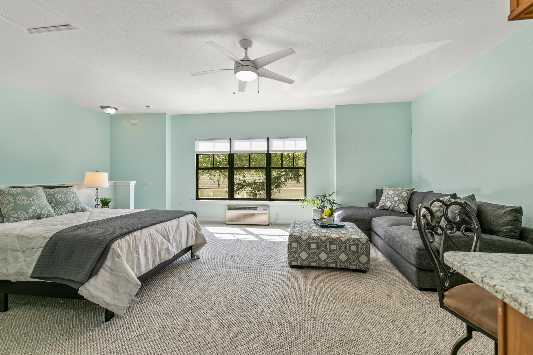 654 Market Street St. Augustine, FL 32095 - Photo 30 of 52 a spacious bedroom with a bed couch and window