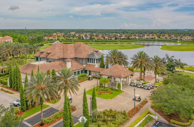 an aerial view of residential houses with outdoor space and swimming pool