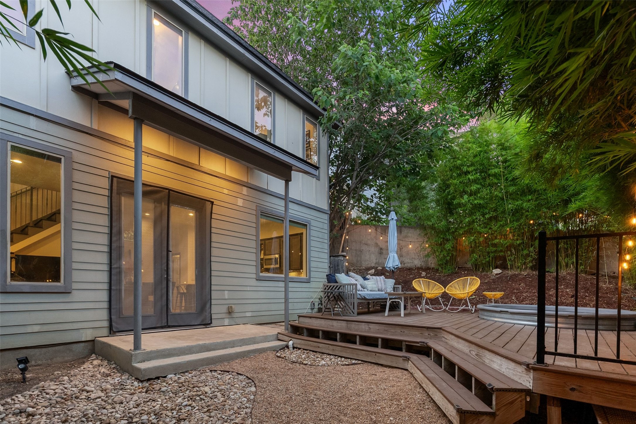 1158 Ridgeway Drive, Unit A Austin, TX 78702 - Photo 23 of 28 An inviting backyard oasis offers a multi-level deck and a secluded space for relaxation and enjoyment.