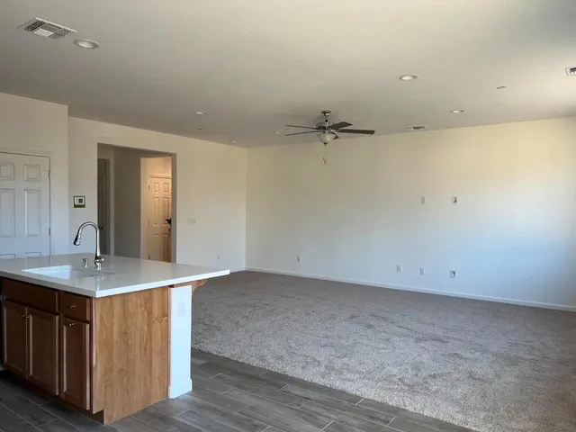 an empty room with a sink and mirror