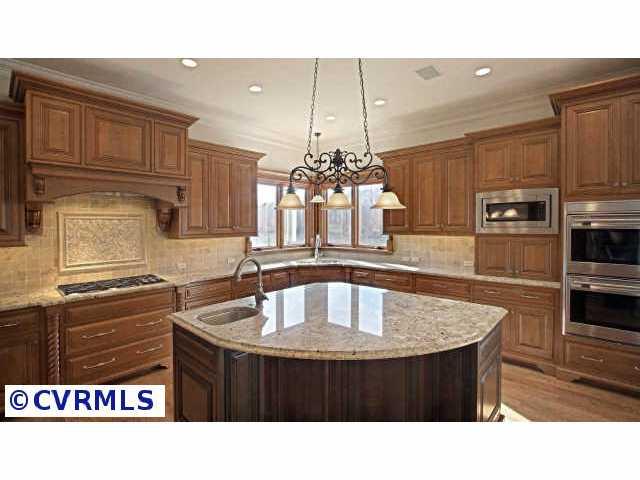 712 Old Stream Road Manakin-Sabot, VA 23103 - Photo 6 of 10 a kitchen with a sink a kitchen island and cabinetry