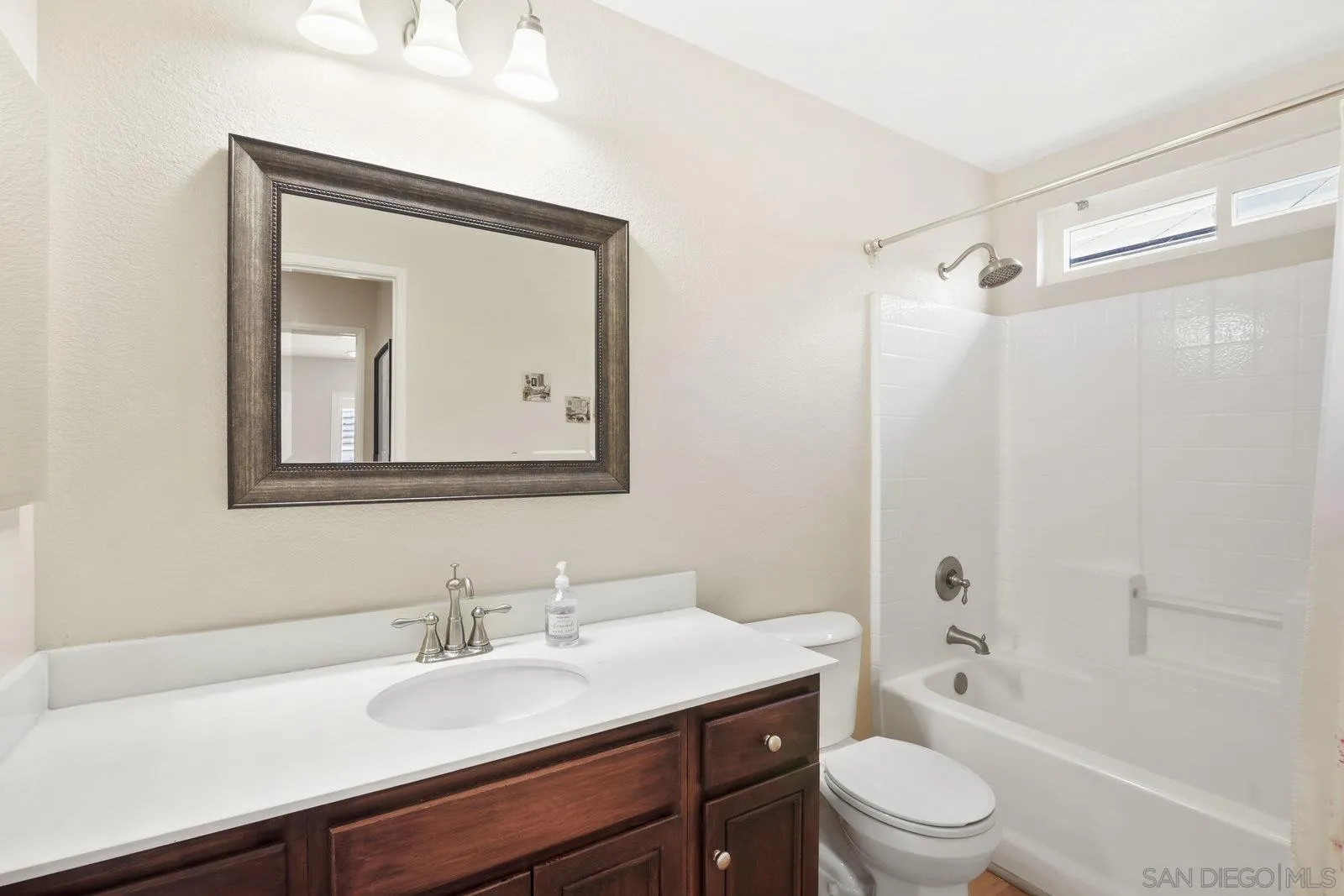 1385 Sunhaven Road Alpine, CA 91901 - Photo 19 of 32 a bathroom with a granite countertop sink a mirror a shower and a bathtub