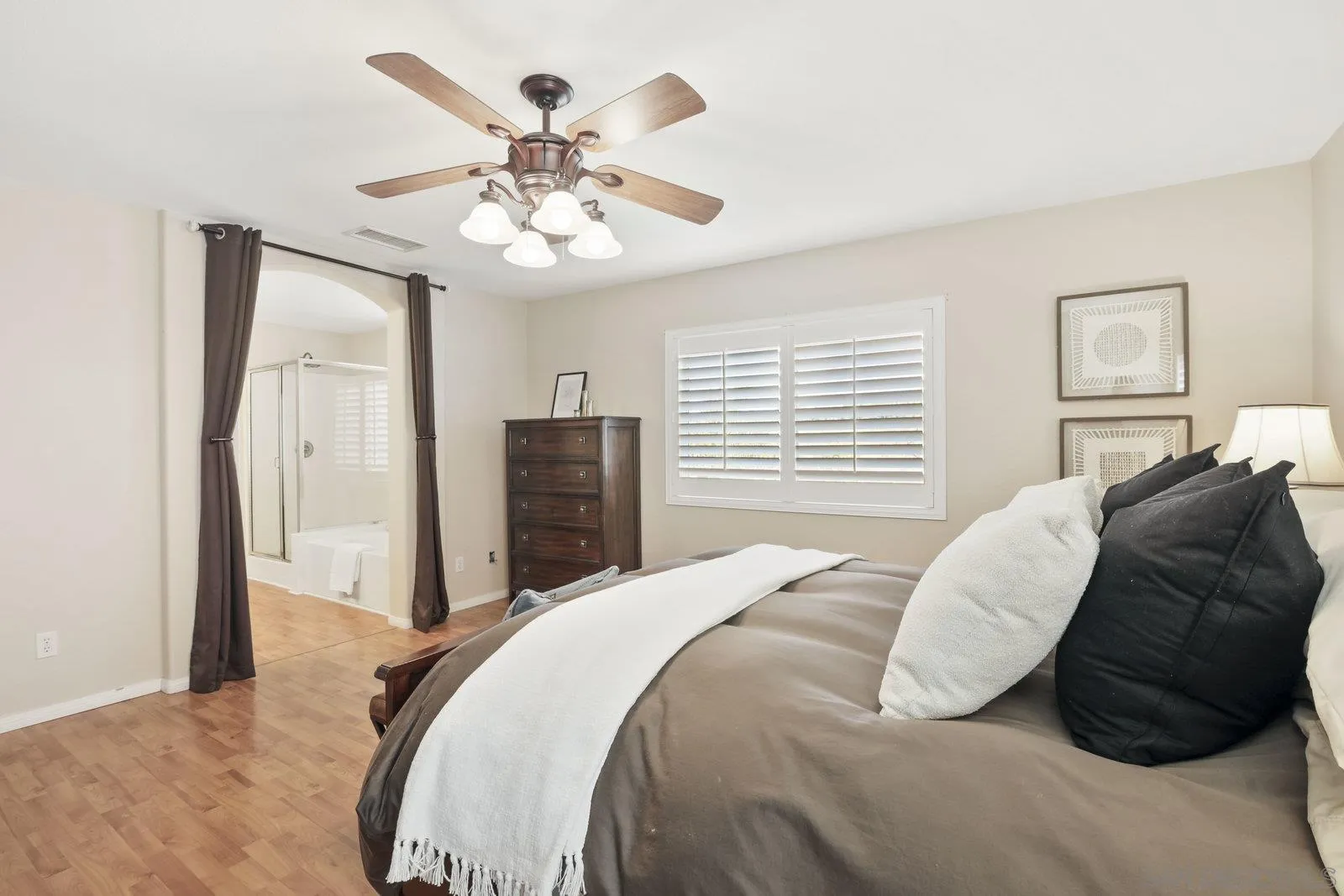 1385 Sunhaven Road Alpine, CA 91901 - Photo 8 of 32 a bedroom with a large bed and a chandelier