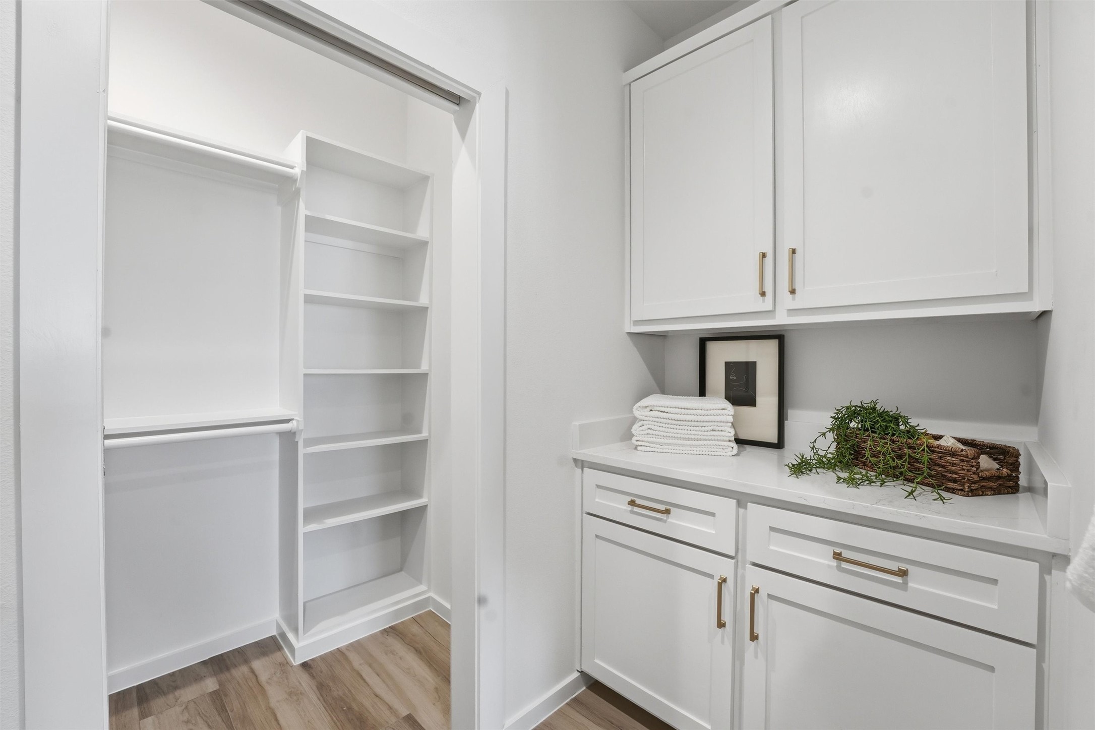528 North 4th Street La Porte, TX 77571 - Photo 18 of 27 a kitchen with white cabinets and a stove with wooden floor