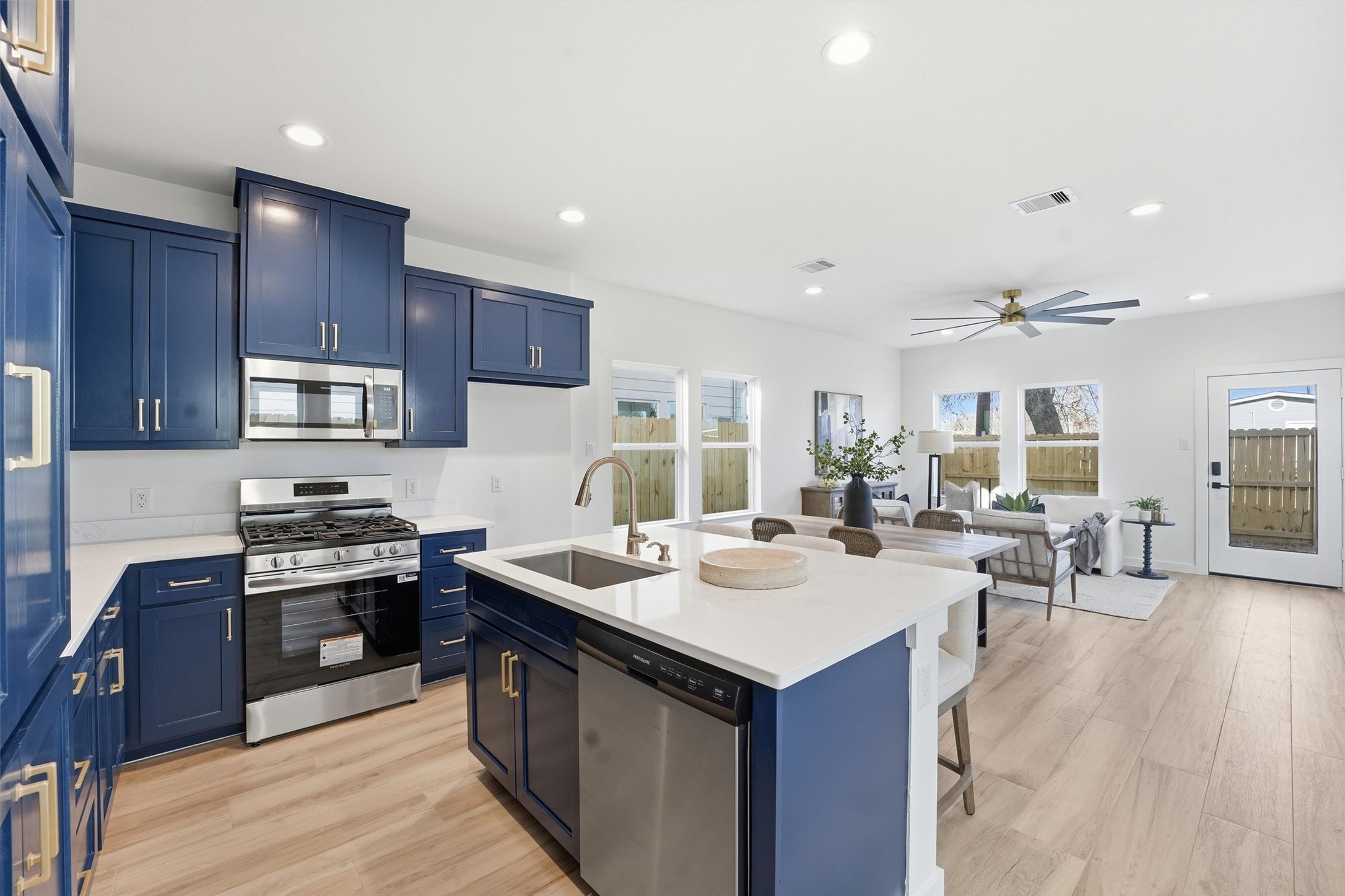 528 North 4th Street La Porte, TX 77571 - Photo 5 of 27 a kitchen with a sink stove and wooden cabinets