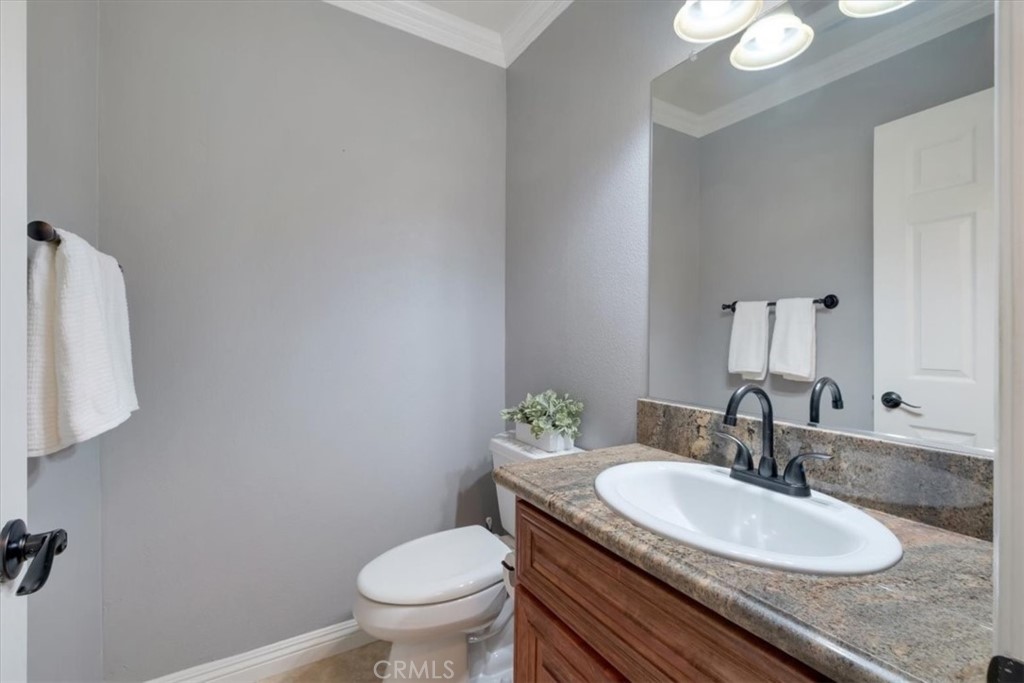 2232 Montague Circle Placentia, CA 92870 - Photo 15 of 36 a bathroom with a granite countertop sink a toilet and a mirror