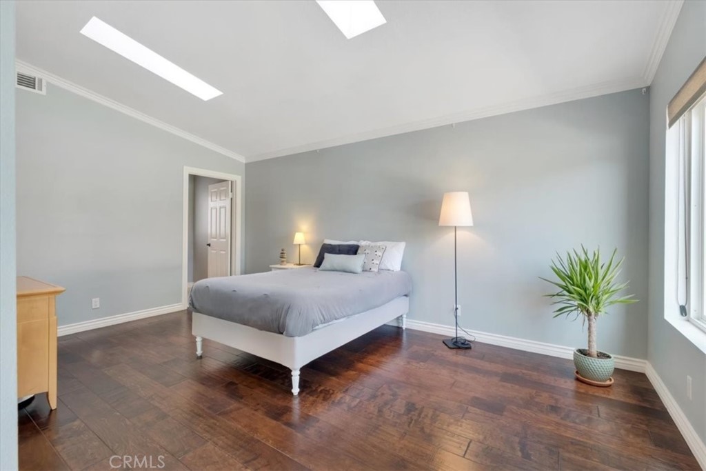 2232 Montague Circle Placentia, CA 92870 - Photo 16 of 36 a bedroom with a bed and a potted plant on the dresser