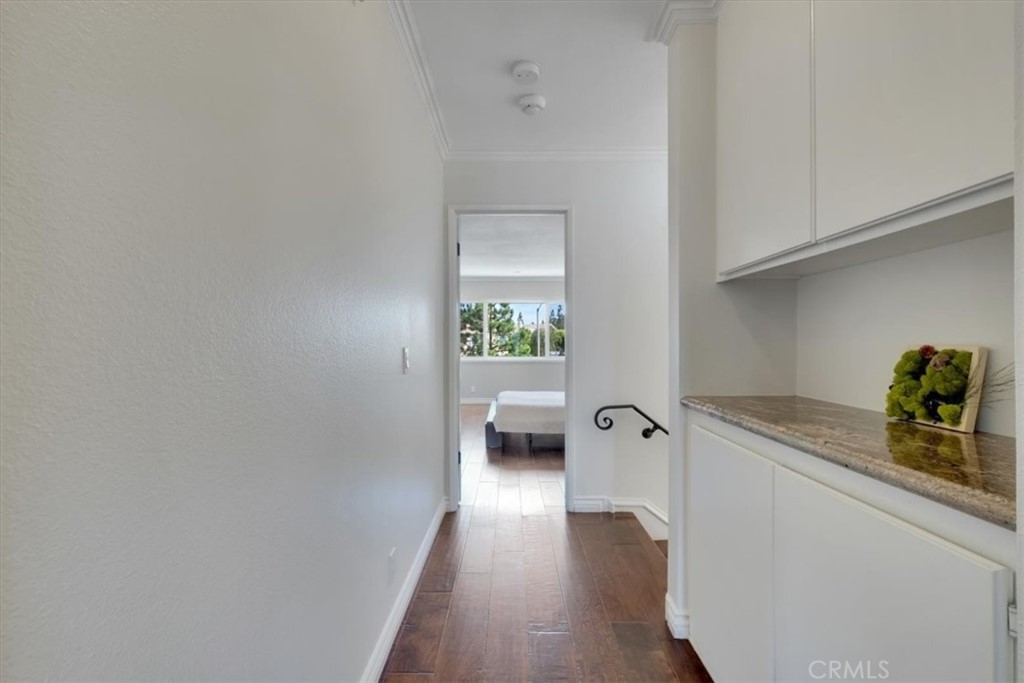 2232 Montague Circle Placentia, CA 92870 - Photo 20 of 36 a hallway with a sink and wooden floor