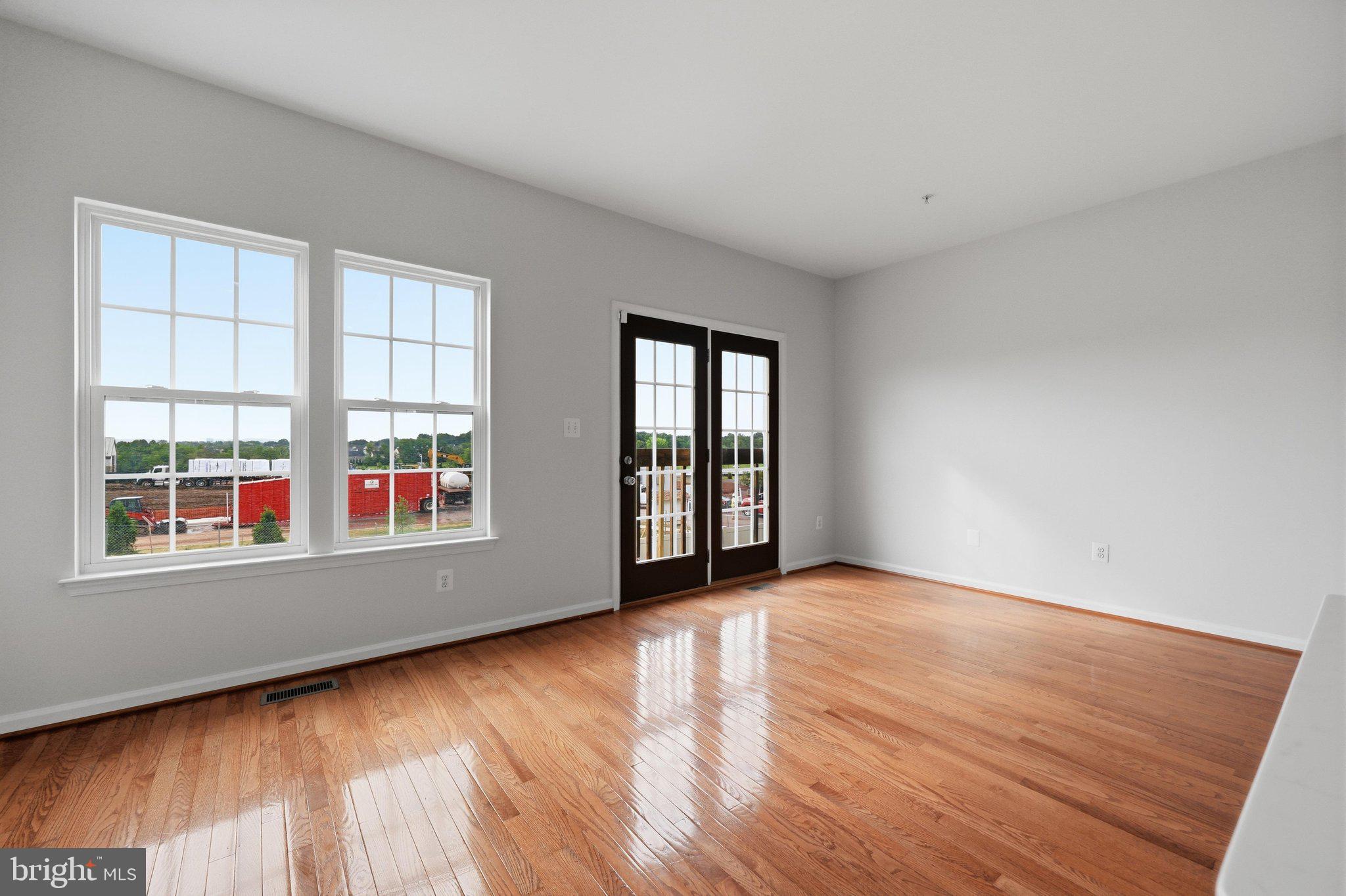 2075 Spring Run Circle Frederick, MD 21702 - Photo 24 of 59 an empty room with wooden floor and windows