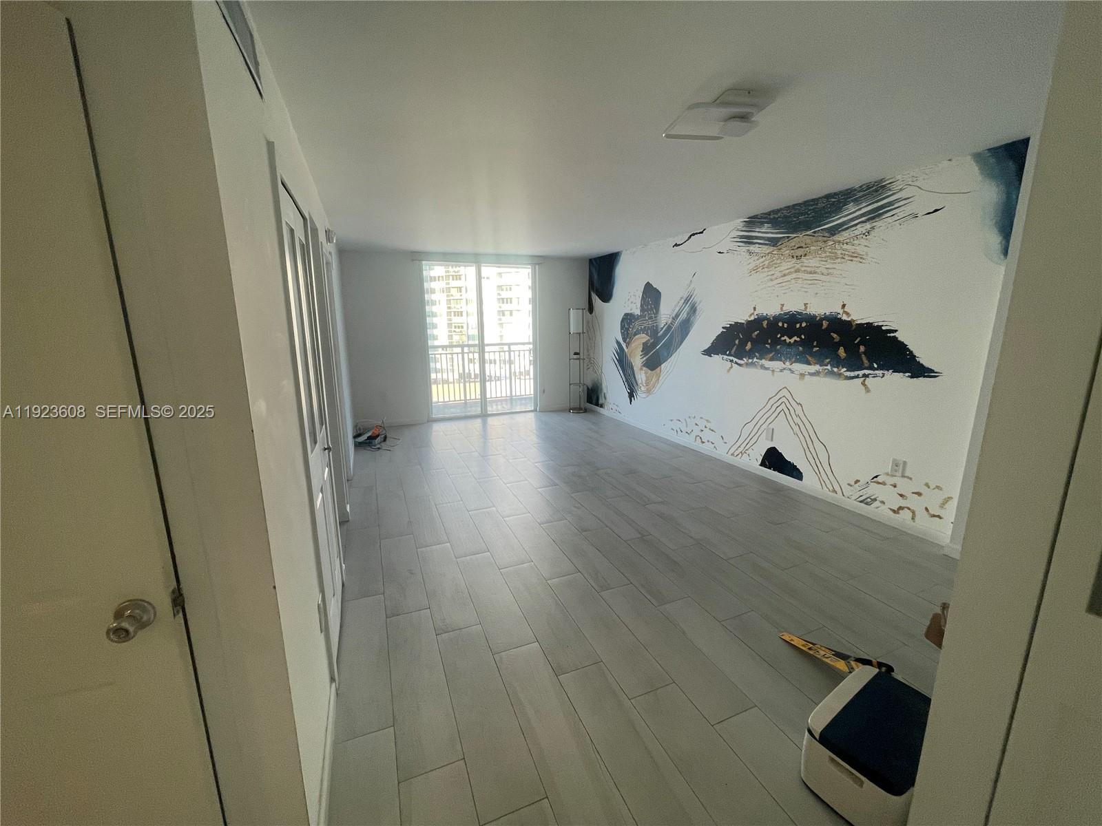 6969 Collins Avenue, Unit 903 Miami Beach, FL 33141 - Photo 5 of 18 a hallway view with hardwood floor