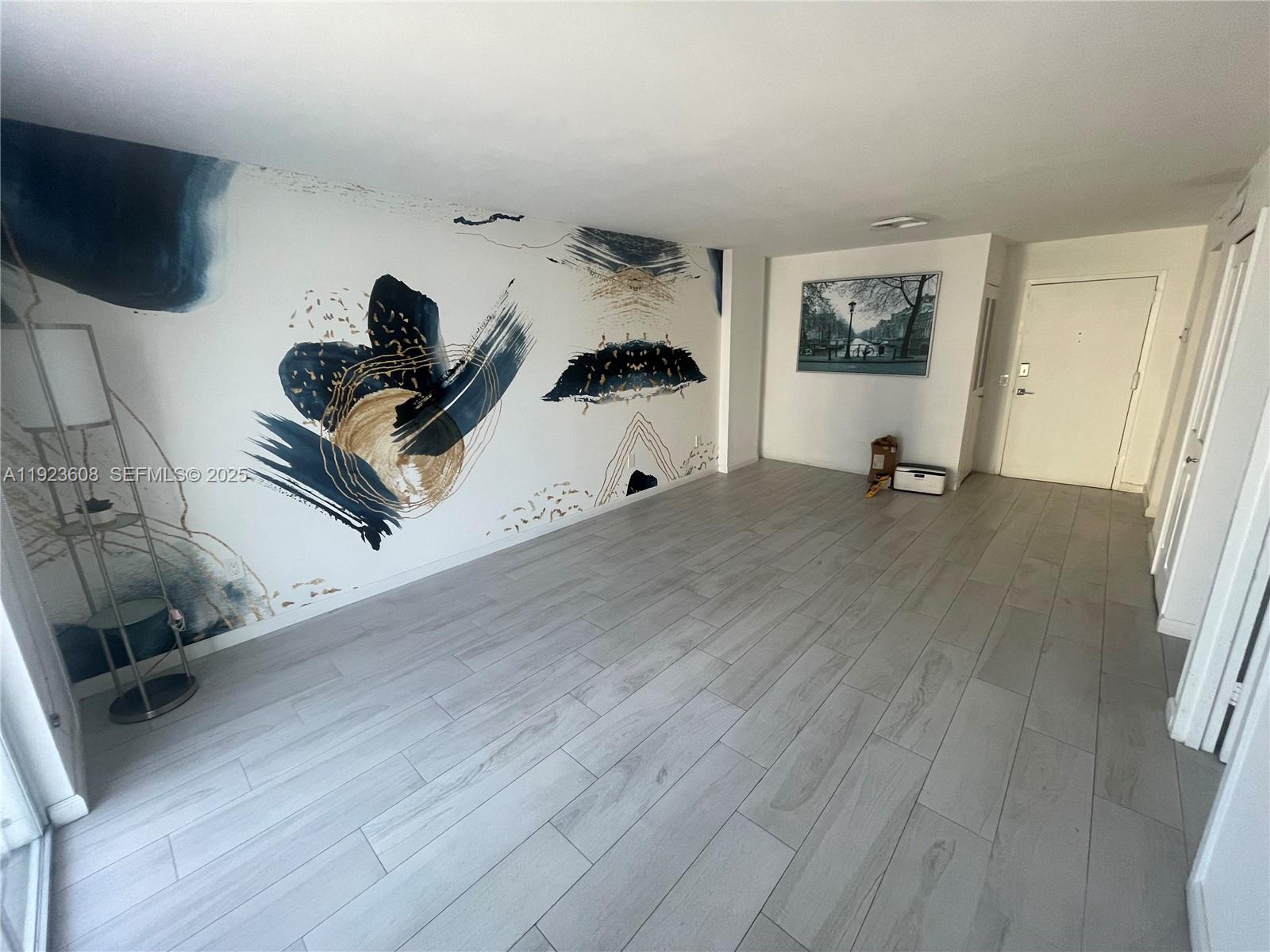 6969 Collins Avenue, Unit 903 Miami Beach, FL 33141 - Photo 6 of 18 a living room with furniture and a wooden floor