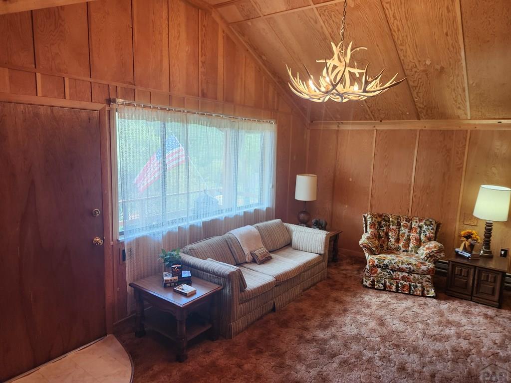 745 Konn Road Rye, CO 81069 - Photo 7 of 11 a living room with furniture a lamp and a window