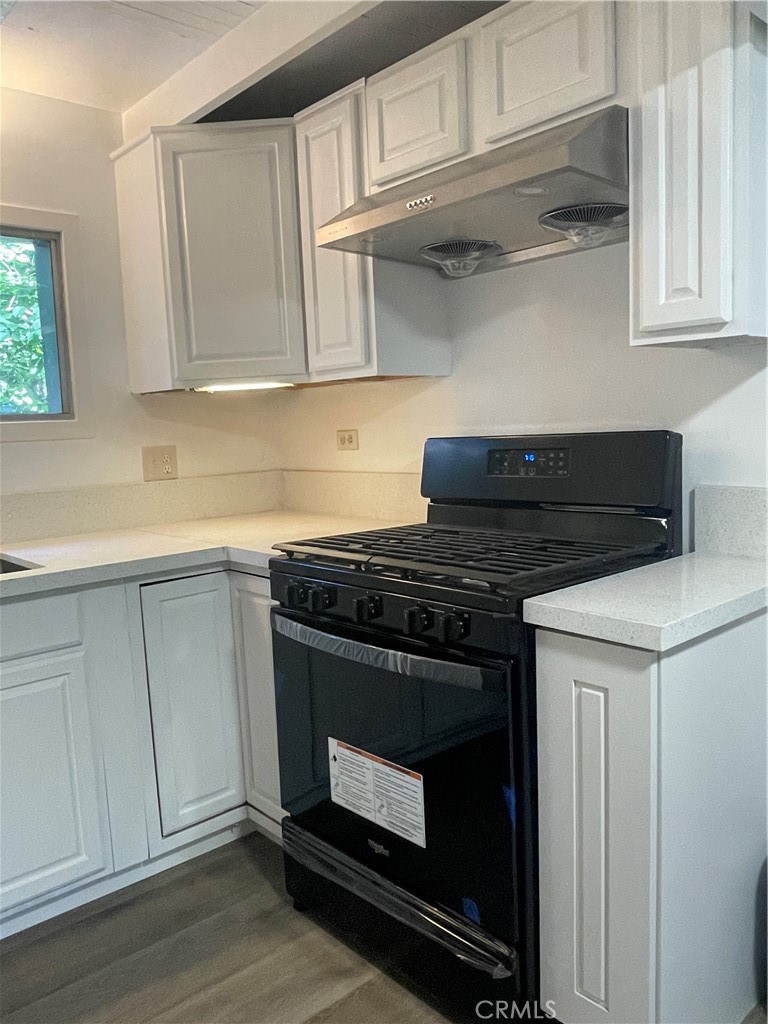719 Woodland Road Crestline, CA 92325 - Photo 13 of 28 a stove top oven sitting inside of a kitchen