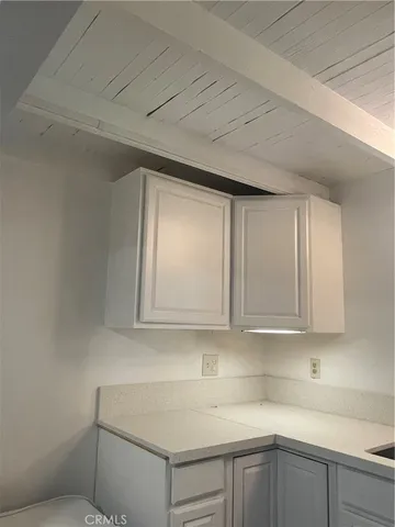 a kitchen with white cabinets and a sink