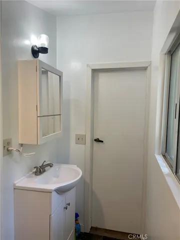 a bathroom with a sink a toilet and mirror
