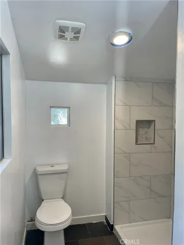 a white toilet sitting next to a bathroom sink