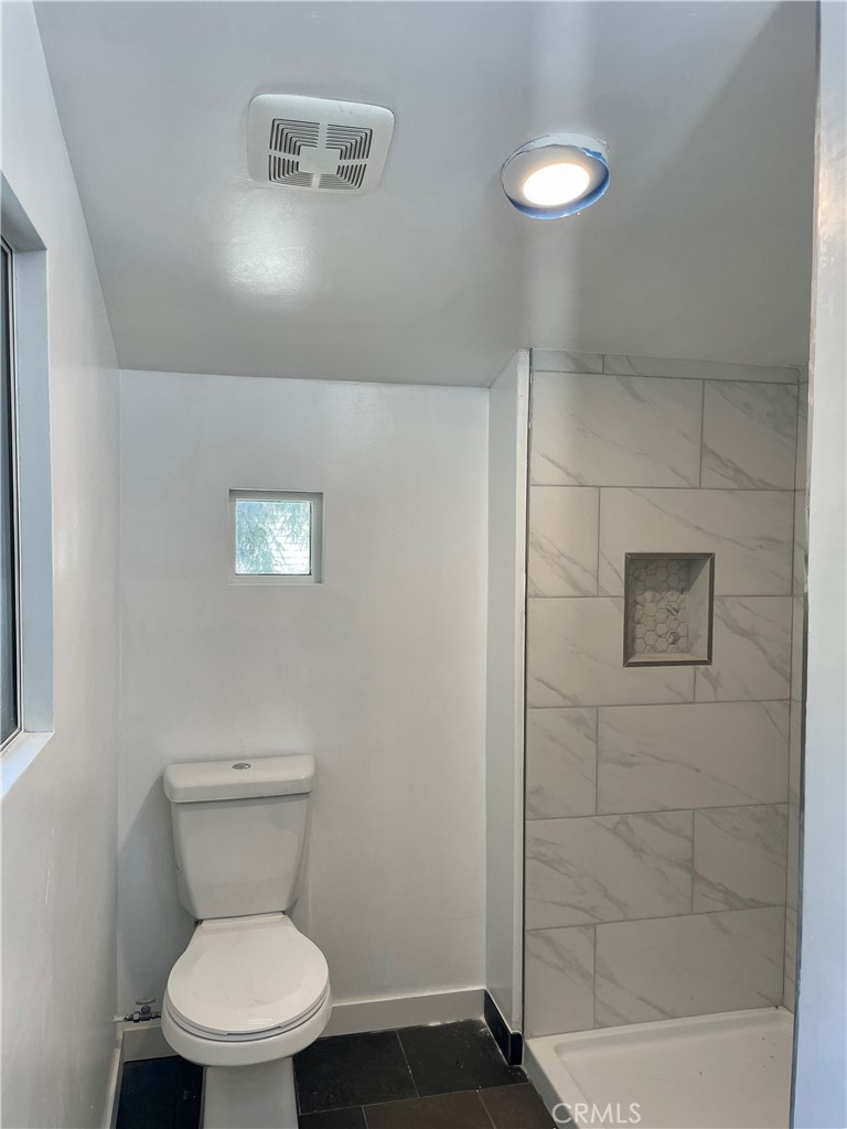 719 Woodland Road Crestline, CA 92325 - Photo 18 of 28 a white toilet sitting next to a bathroom sink