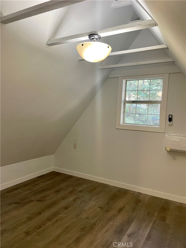 719 Woodland Road Crestline, CA 92325 - Photo 19 of 28 an empty room with wooden floor and windows