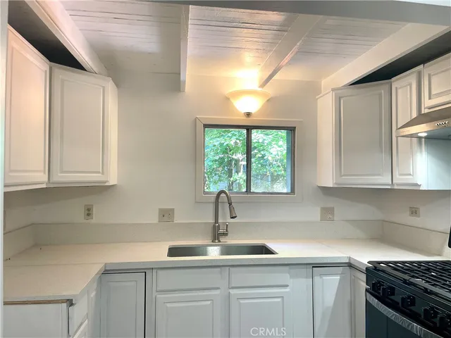 a kitchen with a sink and cabinets