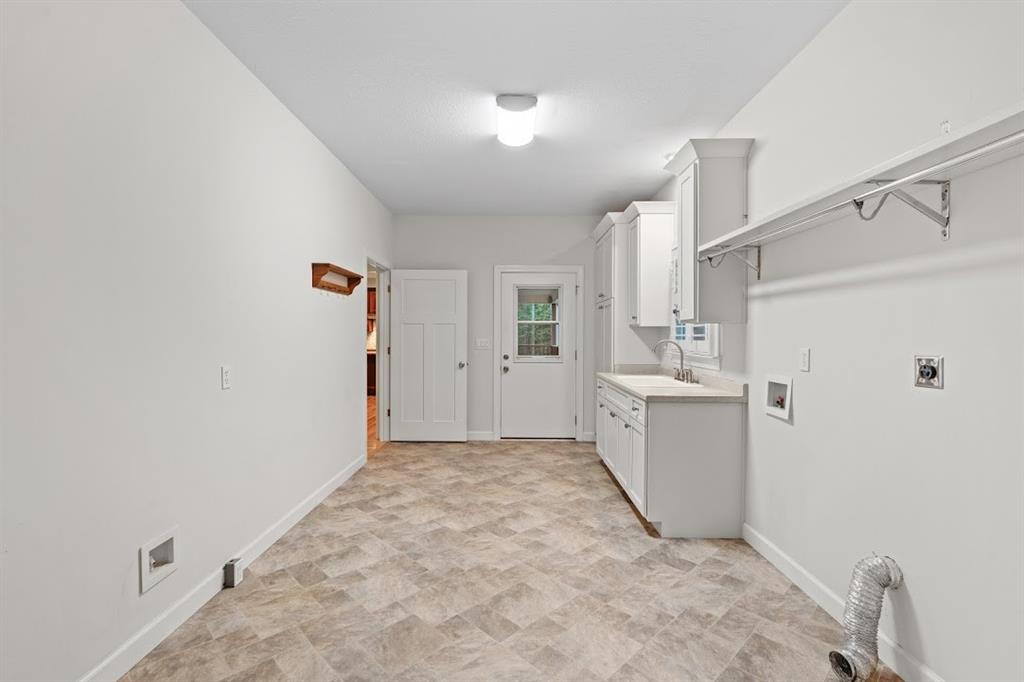 2239 Cross Roads Church Road Buchanan, GA 30113 - Photo 28 of 53 a view of a kitchen with white cabinets and white appliances
